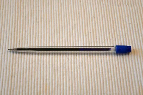 Blue pen on white background Fotos Stock