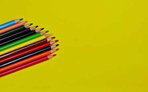 Blue pen with white rests on a stack of colorful foam sheets Stock Photos