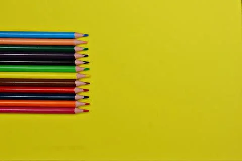 Blue pen with white rests on a stack of colorful foam sheets Stock Photos