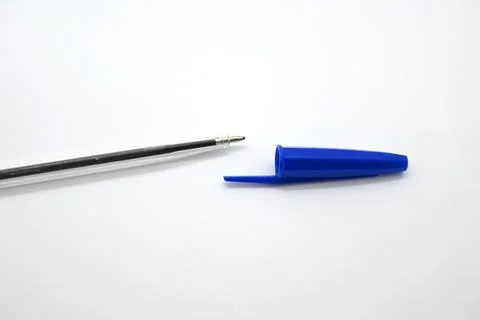 Blue pen without cap next to cap, vulnerability concept, white background, Copy  库存照片