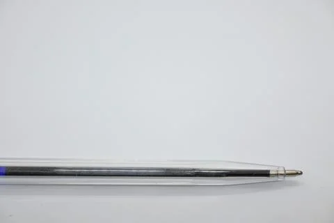 Blue pen without cap on white background, openness and vulnerability concept, Co Stockfoto's