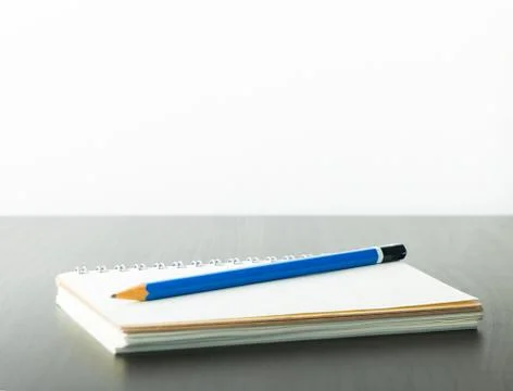 Blue pencil on a notebook with copy space Stock Photos