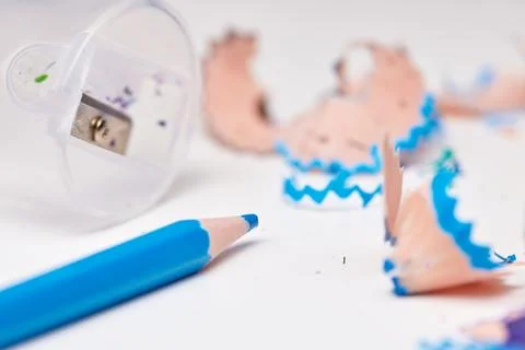 Blue pencil sharpening creating creative wood shavings close up Stock Photos