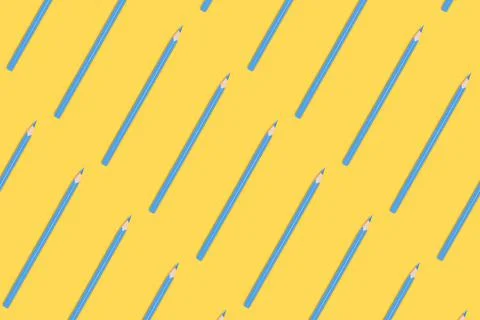 Blue pencils pattern on a yellow background. Stock Photos