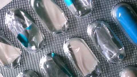 Blue pill leaving blister pack Stock-Footage 311941807