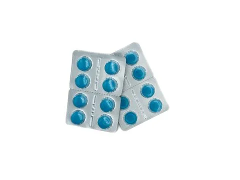 A blue pill is on a white background. There are six pills in total. The pill is Stock Photos