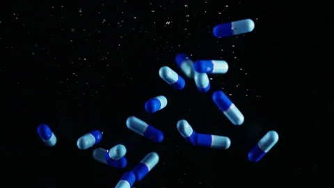 Blue Pills Falling Into Water 2 Stock Footage 78966680