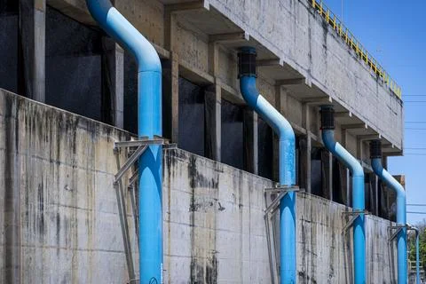 Blue pipe is attached to a building Stock Photos