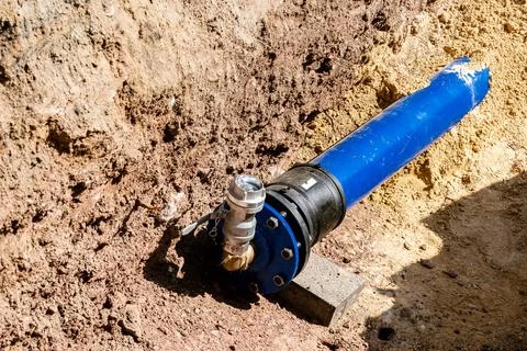 Blue pipe installation for water system in urban area. Stock Photos