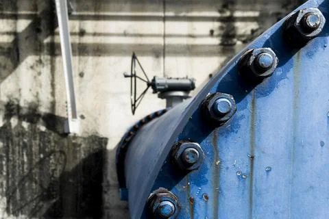 Blue pipe with a metal bolt on top of it Stock Photos
