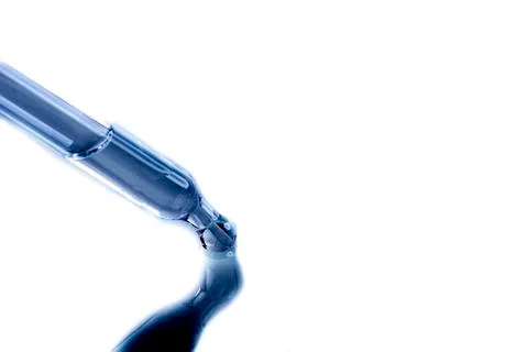 Blue pipeete with blue liquid with a reflection Stock Photos