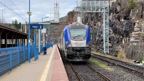 A blue PKP Intercity electric train arrives at a remote railway station Stock Footage 345830917