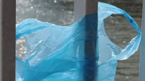 Blue Plastic bag hanging on the railing of Elisabeth bridge over Donau rive.. Stock-Footage 273585956