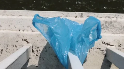 Blue Plastic bag hanging on the railing of Elisabeth bridge over Donau rive.. Stock-Footage 277682892
