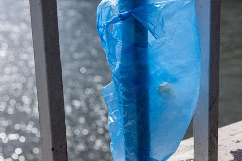 Blue Plastic bag hanging on the railing of Elisabeth bridge over Donau rive.. Stock Photos