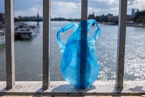 Blue Plastic bag hanging on the railing of Elisabeth bridge over Donau rive.. Stock Photos