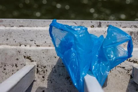 Blue Plastic bag hanging on the railing of Elisabeth bridge over Donau rive.. Stock Photos