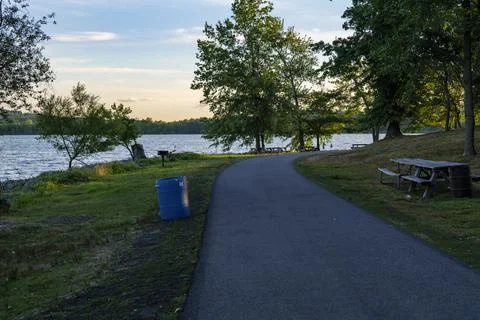 Blue plastic barrel for garbage in a park near Rockland Lake, New York. Stock Photos