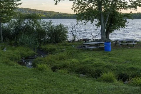 Blue plastic barrel for garbage in a park near Rockland Lake, New York. Stock Photos
