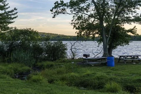 Blue plastic barrel for garbage in a park near Rockland Lake, New York. Stock Photos