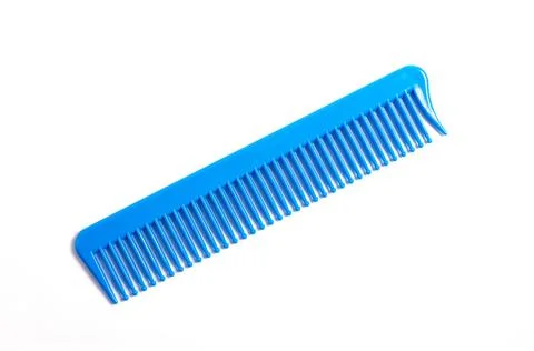 Blue plastic comb on a white background. Stock Photos