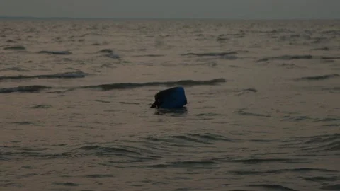 Blue Plastic Container Floating in Ocean - Environmental Pollution Concept Stock Footage 239172436