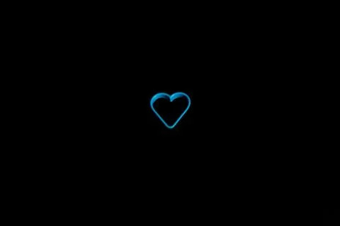 Blue plastic cookie cutter for making cookies in the shape of a heart on a bl Stock Photos