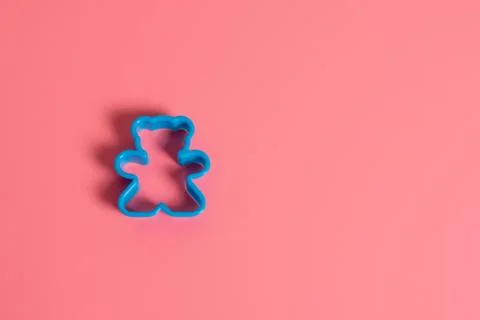 Blue plastic cookie cutter for making cookies in the shape of a teddy bear on Stock Photos