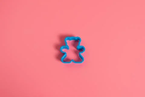 Blue plastic cookie cutter for making cookies in the shape of a teddy bear on Stock Photos