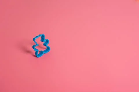 Blue plastic cookie cutter for making cookies in the shape of a teddy bear on Stock Photos