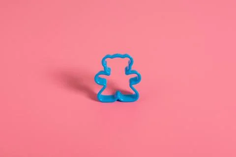 Blue plastic cookie cutter for making cookies in the shape of a teddy bear on Stock Photos