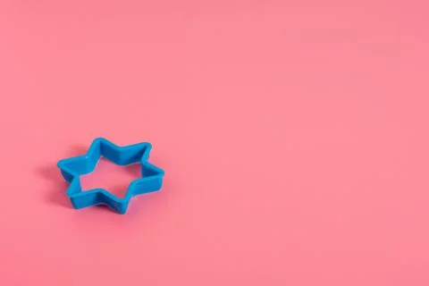 Blue plastic cookie cutter for making cookies in the shape of a star on a pin Stock Photos