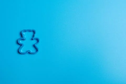 Blue plastic cookie cutter for making cookies in the shape of a teddy bear on Stock Photos