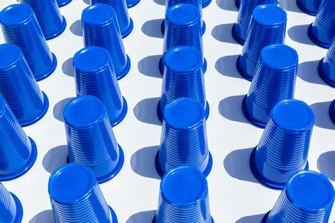 Blue Plastic Drinking Cups in rows background Stock Photos