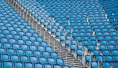 Blue plastic empty stadium  chairs in a row Stockfoto's