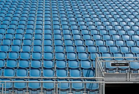 Blue plastic empty stadium  chairs in a row Stockfoto's