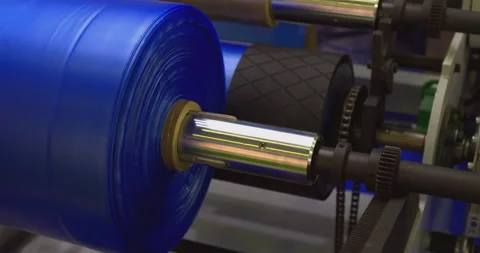 Blue plastic film rolling on rollers in production line Stock Footage 301076453