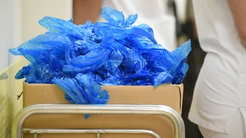 Blue plastic shoes covers in a box inside a hospital 스톡 동영상 250170028