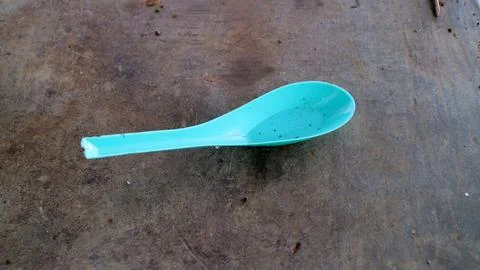 Blue Plastic Spoon on Textured Surface Stock Photos