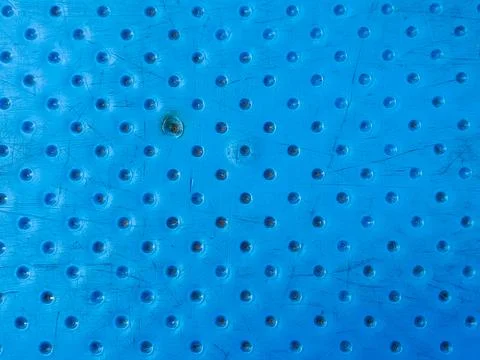 Blue plastic table surface featuring a repeating circular pattern 스톡 사진