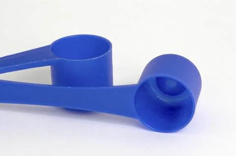 Blue plastic teaspoons on white background Stock Photos
