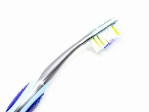 Blue plastic toothbrush on a white background. Stock Photos