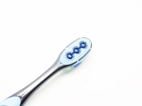 Blue plastic toothbrush on a white background. Stock Photos
