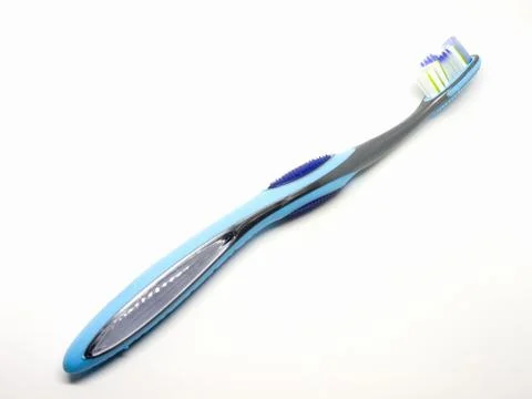 Blue plastic toothbrush on a white background. Foto stock