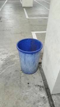 Blue Plastic Trash Bin in Empty Parking Garage Stock Photos