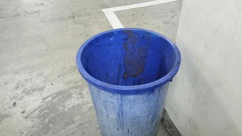 Blue Plastic Trash Bin in Empty Parking Garage Stock Photos
