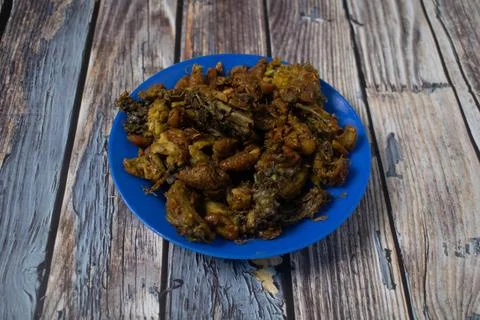 A blue plate filled with crispy fried chicken skin Stock Photos