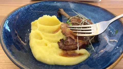 On a blue plate a piece of meat with mashed potatoes Stock Footage 284925682