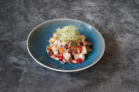 A blue plate with a salad on it Stock Photos