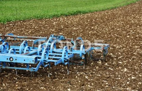 A blue plough in the field Stock Photos